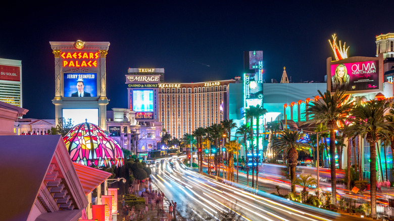 Streets, signs, and buildings lit up with colorful, neon lights at night in Las Vegas.