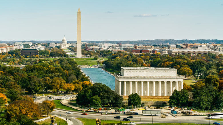 Helicopter shot of the the National Mall in Washington, D.C. on a sunny day in Fall, looking over the Lincoln Memorial and past the Washington Monument Towards Capitol Hill.