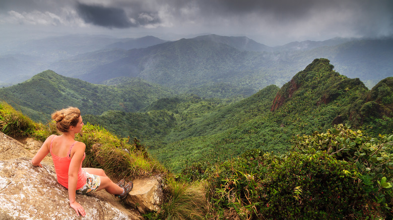 Adventurous woman looking over El Yunque in Puerto Rico
