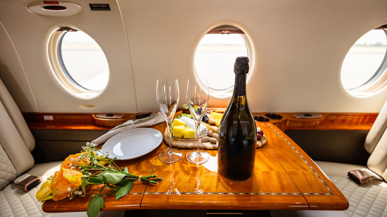 Bottle of wine at a premium seat table on an airplane