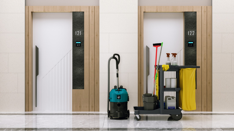 Cleaning equipment parked outside of two hotel rooms.