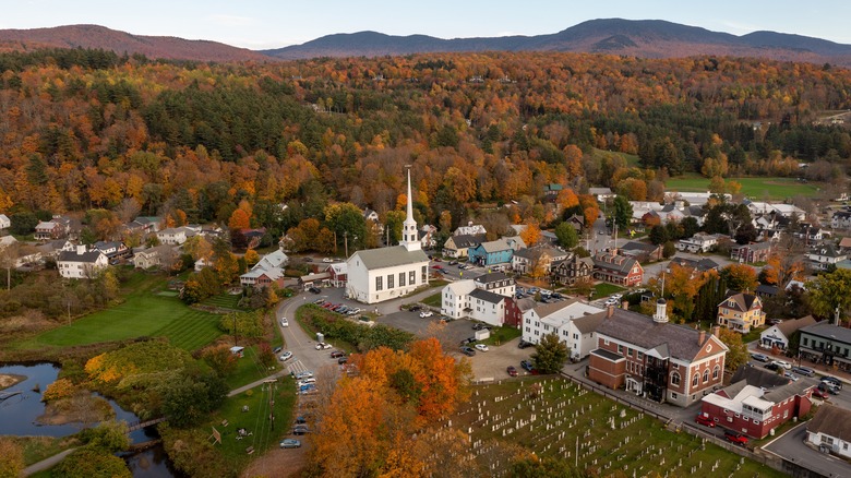 Historic homes surrounding the Stowe Community Church in Stowe Vermont in fall with autumnal colors