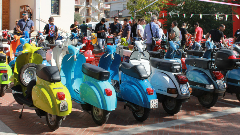 Several Vespas parked in an Italian town