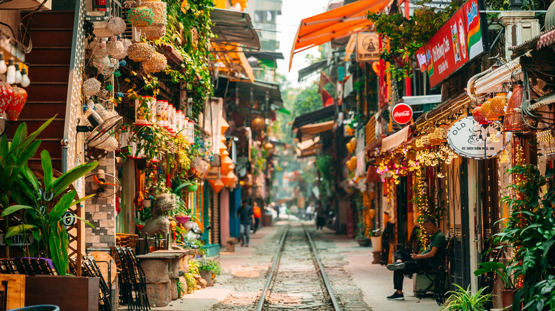 A railway line runs through a quaint market in Hanoi, Vietnam