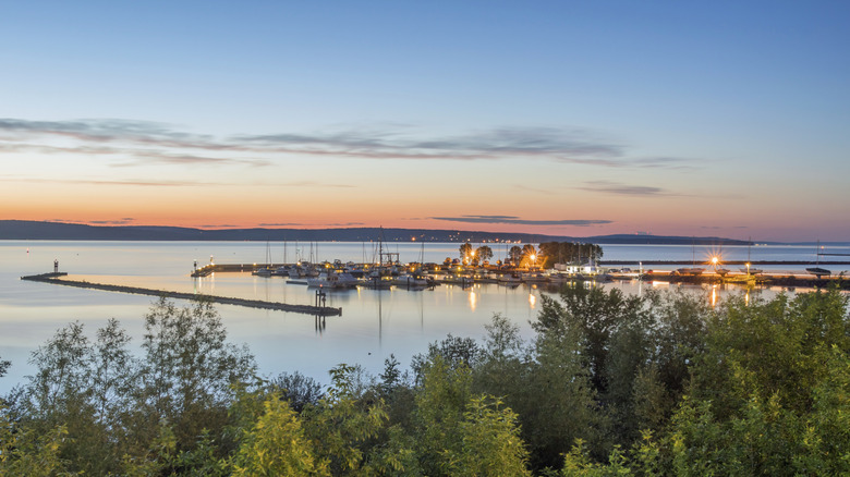 A faraway shot of the Ashland marina in the evening light with calm reflective water