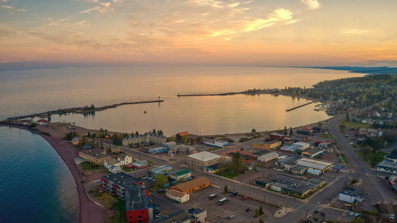 An aerial view on Grand Marais in the evening with two break walls creating a small bay