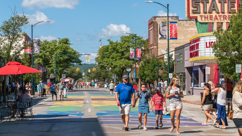 People walking the bright summer tree-lined streets of Traverse City