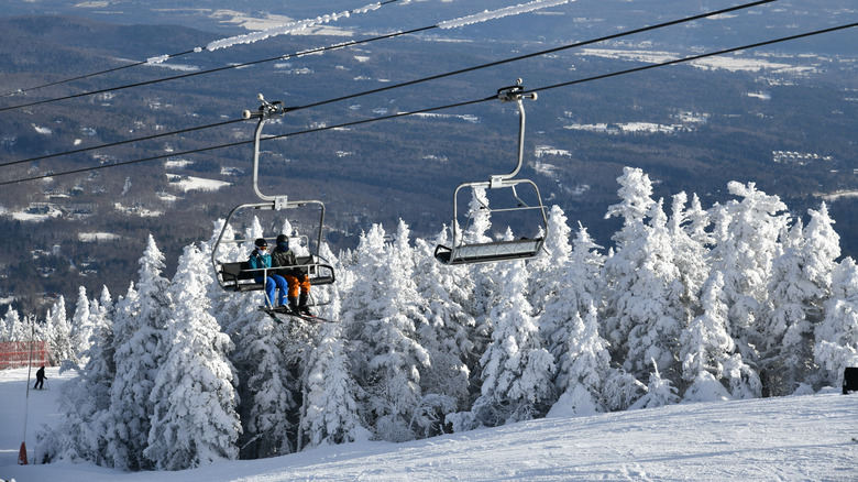 Chair lifts hover above snow-glazed firs in Stowe, Vermont.