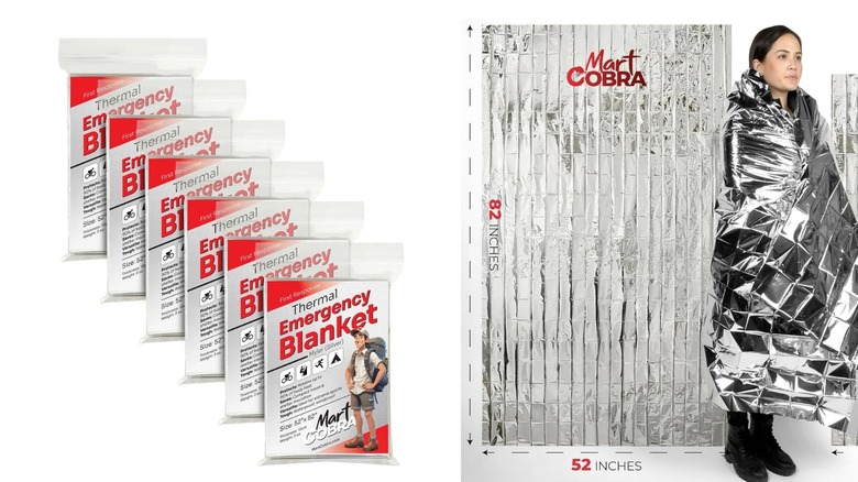 A woman wearing a silver thermal blanket for winter camping