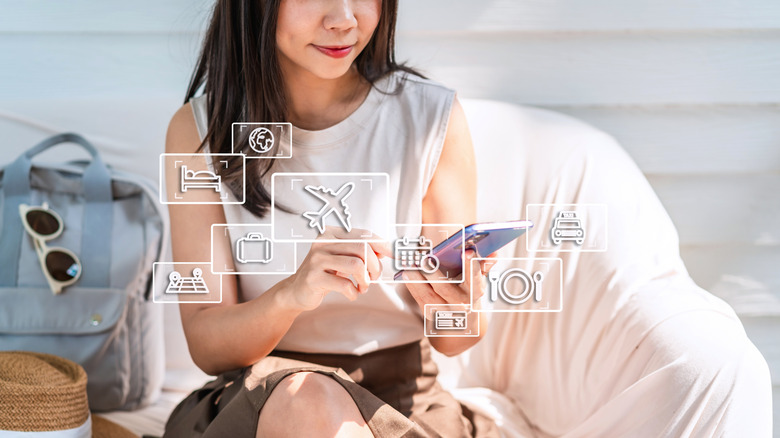 Woman smiling making travel plans on her phone