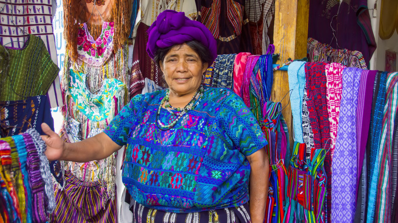 An artisan woman sells textiles from her stand