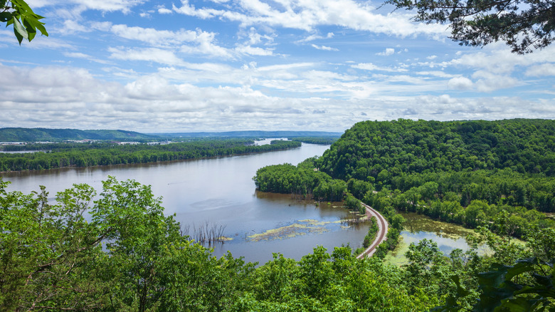A hilltop photo of the Mississippi River in Wisconsin with a road crossing an estuary
