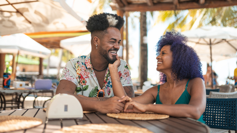 A couple laughing and relaxing at an outdoor Brazilian restaurant