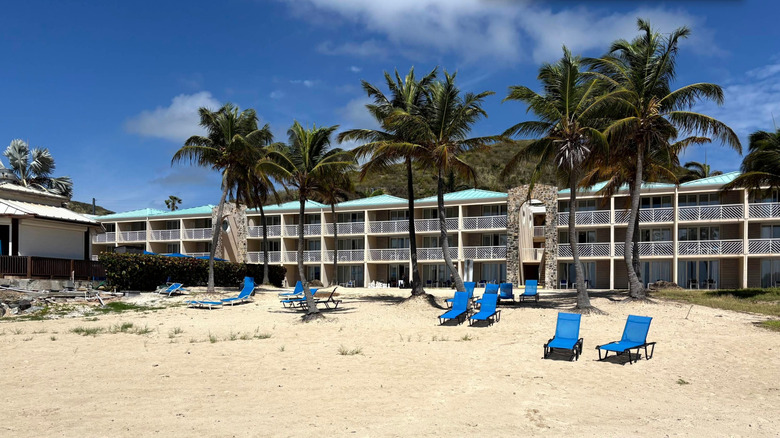 Carnia Bay Resort's beach and rooms on a sunny day