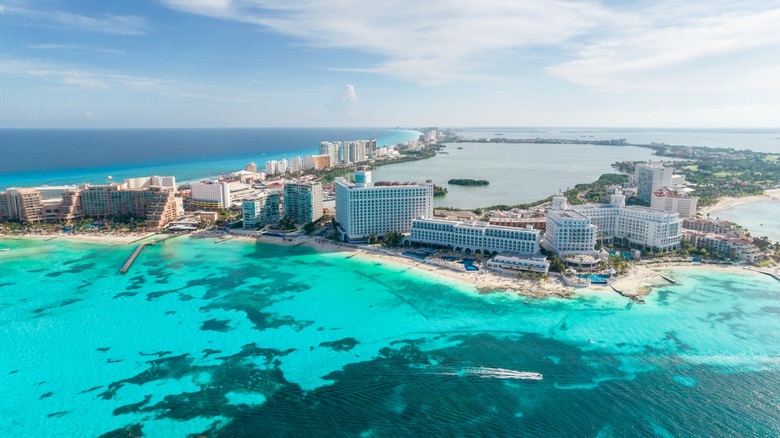 Buildings next to the water in the resort zone of Cancun, Mexico, viewed from above.