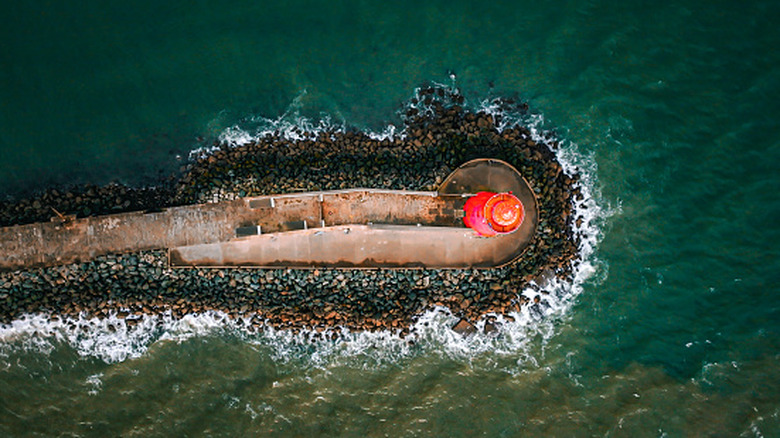 Overhead view of the Poolbeg Lighthouse and jetty leading to it surrounded by water