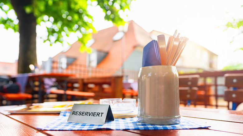 A German beer garden with a table sporting a reserved sign