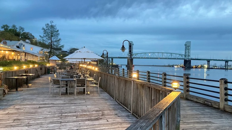 Waterfront restaurant tables along the boardwalk at Wilmington Riverwalk