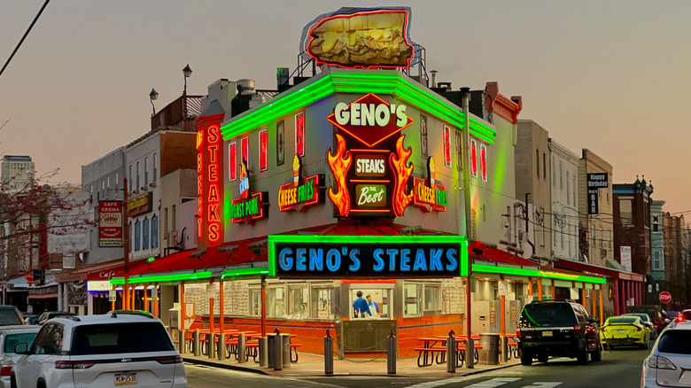 Exterior shot of Geno's Steaks at dusk, with illuminated neon lights
