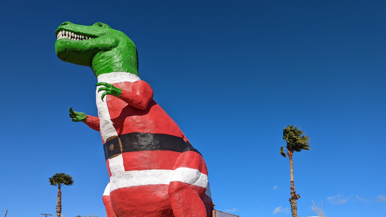 A T-Rex statue in a Santa Claus Suit at Cabazon Dinosaurs in California
