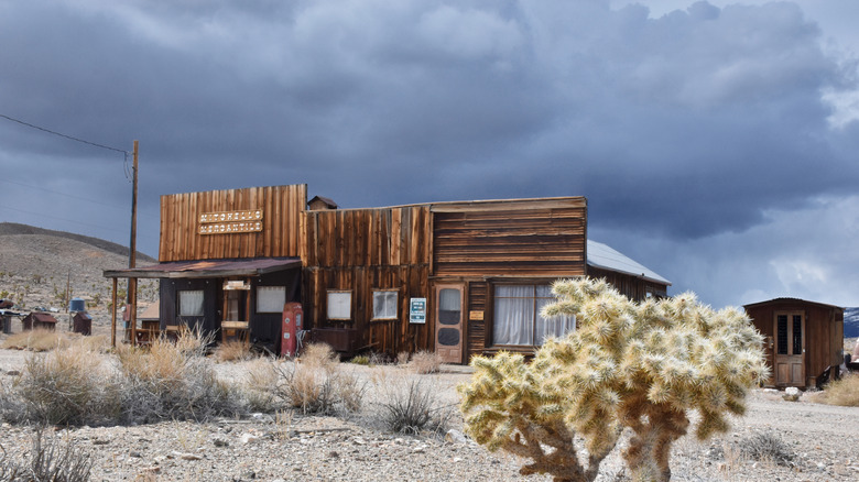 Historic wooden mercantile building in the ghost town of Gold Point with sagebrush field surrounding it