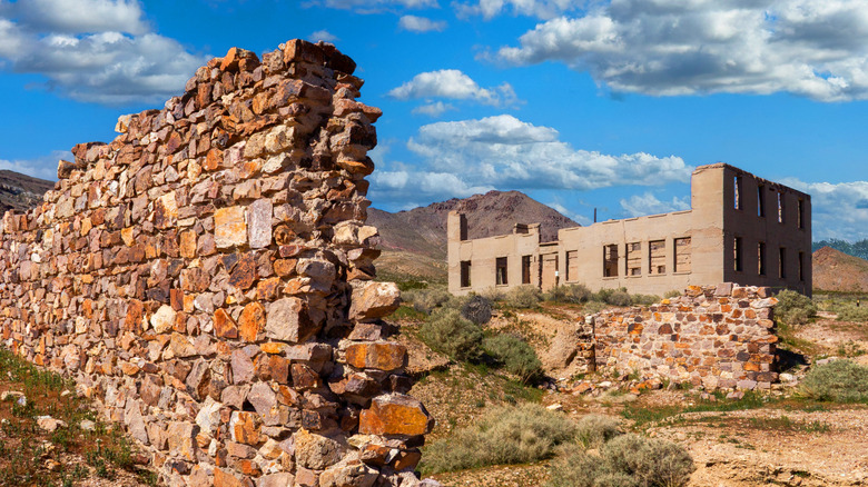 Remains of the Rhyolite schoolhouse and dilapidated stone wall surounding it