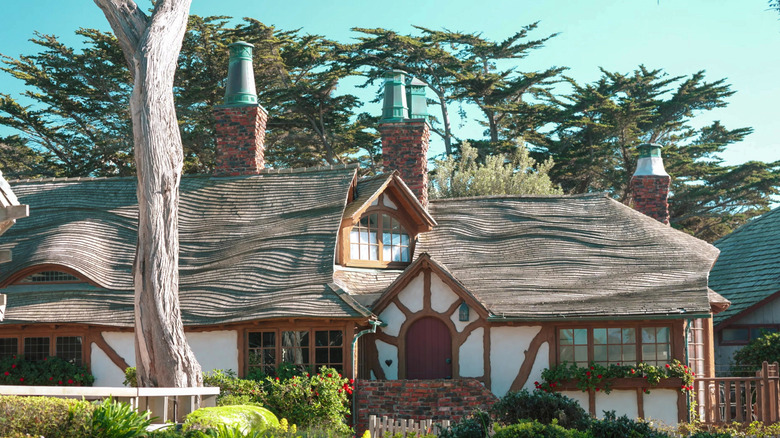 A Comstock cottage surrounded by tall trees in Carmel, California.