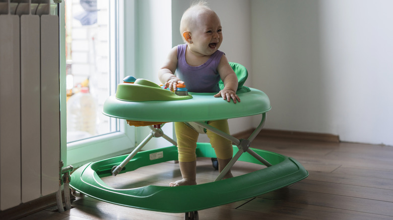 An infant in a baby walker