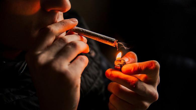 A man about to smoke a marijuana joint