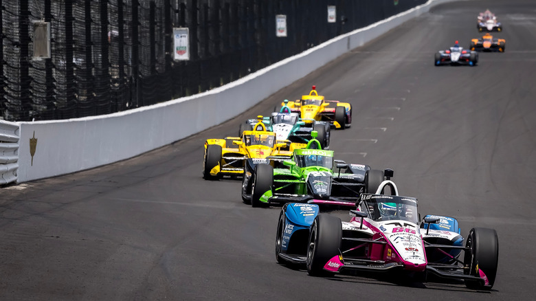 Cars racing on the track at Indianapolis Motor Speedway