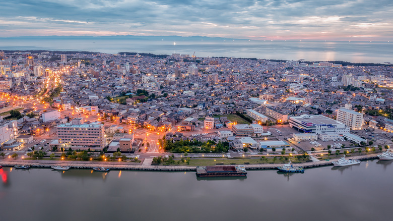 aerial view of niigata city at night and sea of japan in background