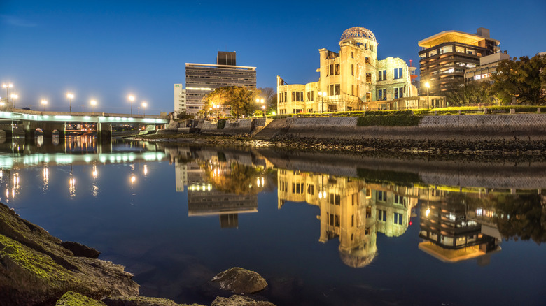 ruins from the atomic bomb lit up at night along the river