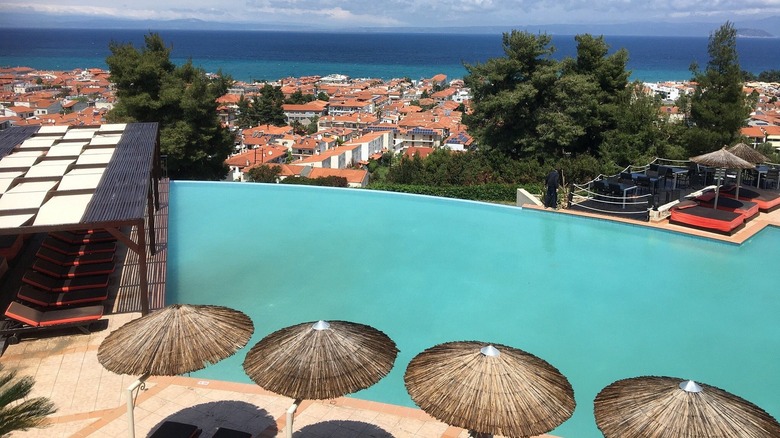 View of the pool, sea, and town below from Alia Palace Hotel in Halkidiki