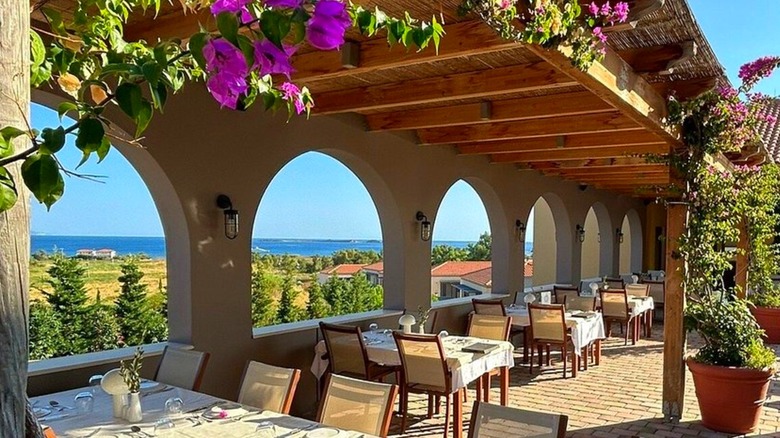 A dining area with coastal views at the Apollonion Asterias Resort in Kefalonia
