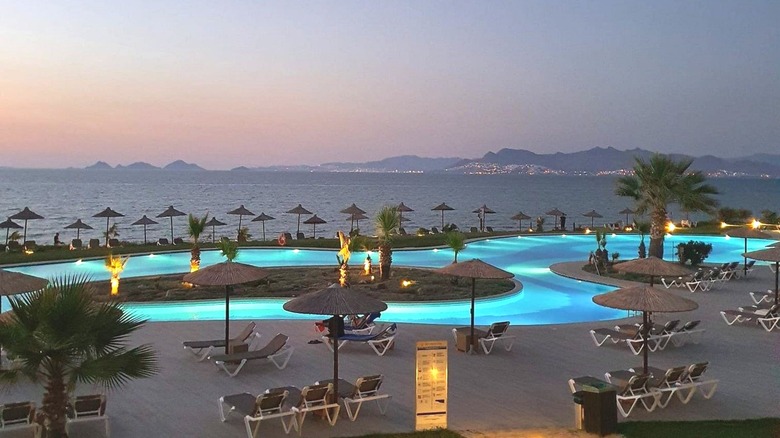 A view of the pool at the Astir Odysseus Kos Resort & Spa at dusk