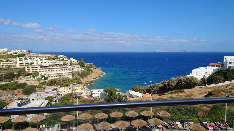 Balcony view of the pool and the Cretan Sea from a room at Blue Bay Resort Hotel in Crete