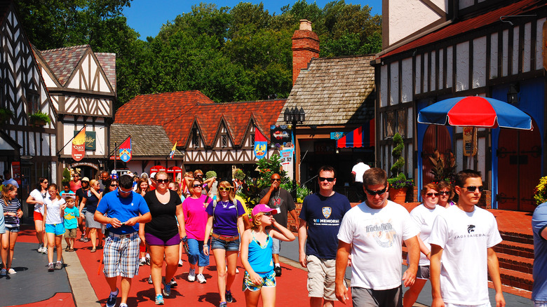 Park goers walk through a recreated Tudor-style English village in Busch Gardens Williamsburg