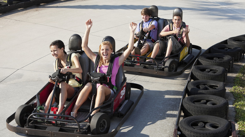 Teenagers riding in go-karts