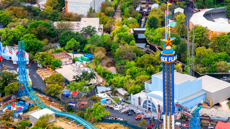 Aerial view of Six Flags Over Texas with a drop tower ride in the foreground