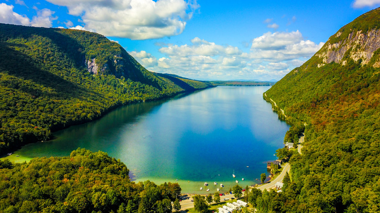 Blue waters of Lake Willoughby, Vemont surrounded by forested mountain peaks.