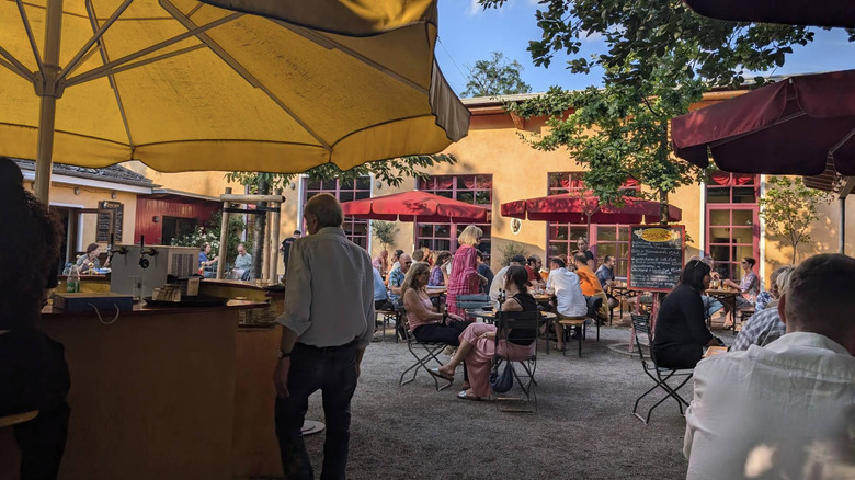 People mingling at Alteburg beer garden in Cologne