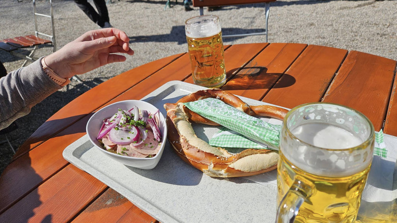 Food and beer on a table at Zum Flaucher Biergarten in Munich