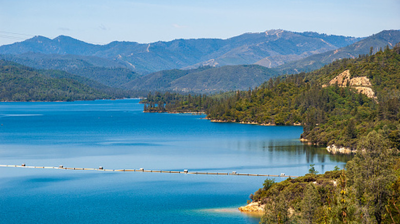 An aerial view of Whiskeytown National Recreation Area with a lake surrounded by tree-covered mountains