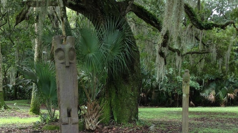 Owl totem in front of a tree at Hontoon Island State Park, Florida.