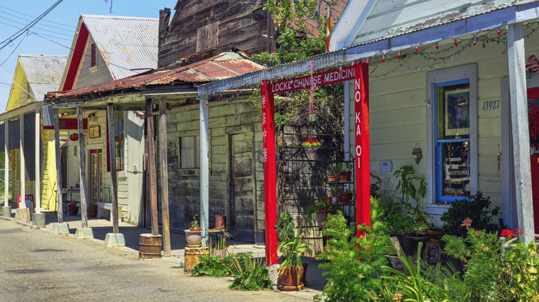 A bright red awning against a row of faded traditional houses in Locke, California