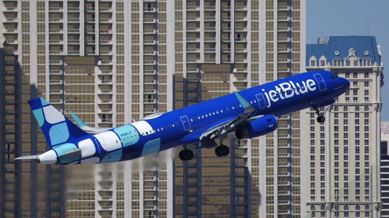 A JetBlue Airbus A321 airplane departs from Harry Reid International Airport en route to Ontario with The Signature at MGM Grand in the background on March 11, 2026 in Las Vegas, Nevada