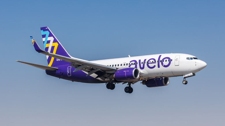 Avelo Airlines in the air over Burbank Airport with a clear blue sky