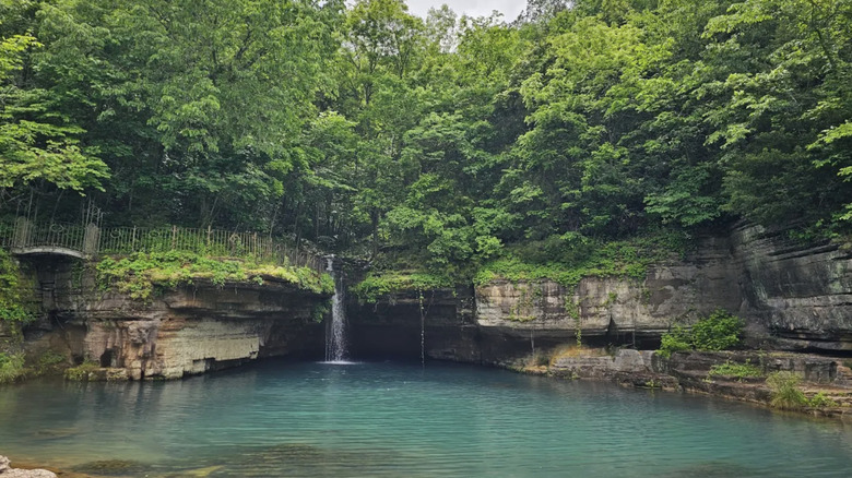 limestone bluffs, and a pool of azure water, surrounded by greenery at Dogwood Canyon Nature Park, Missouri