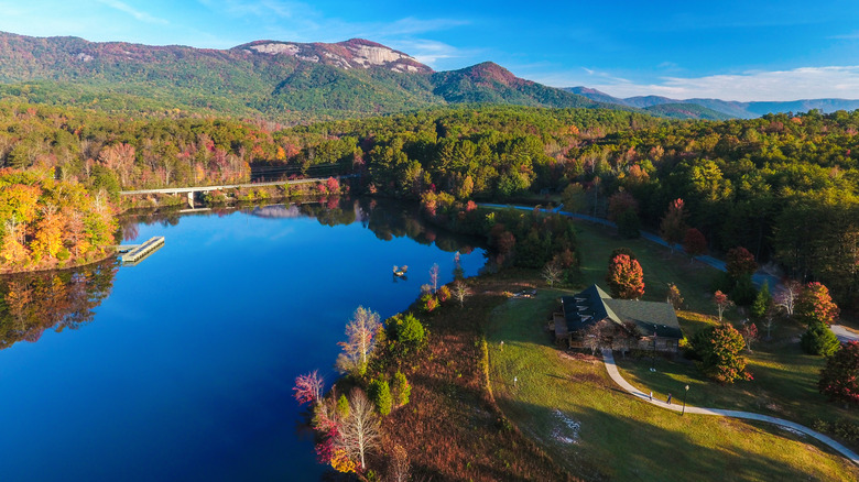 aerial view of alake surrounded by trees with a mountain in the distance in Table Rock State Park in Missouri