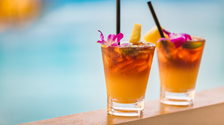 two mai tais on a ledge
